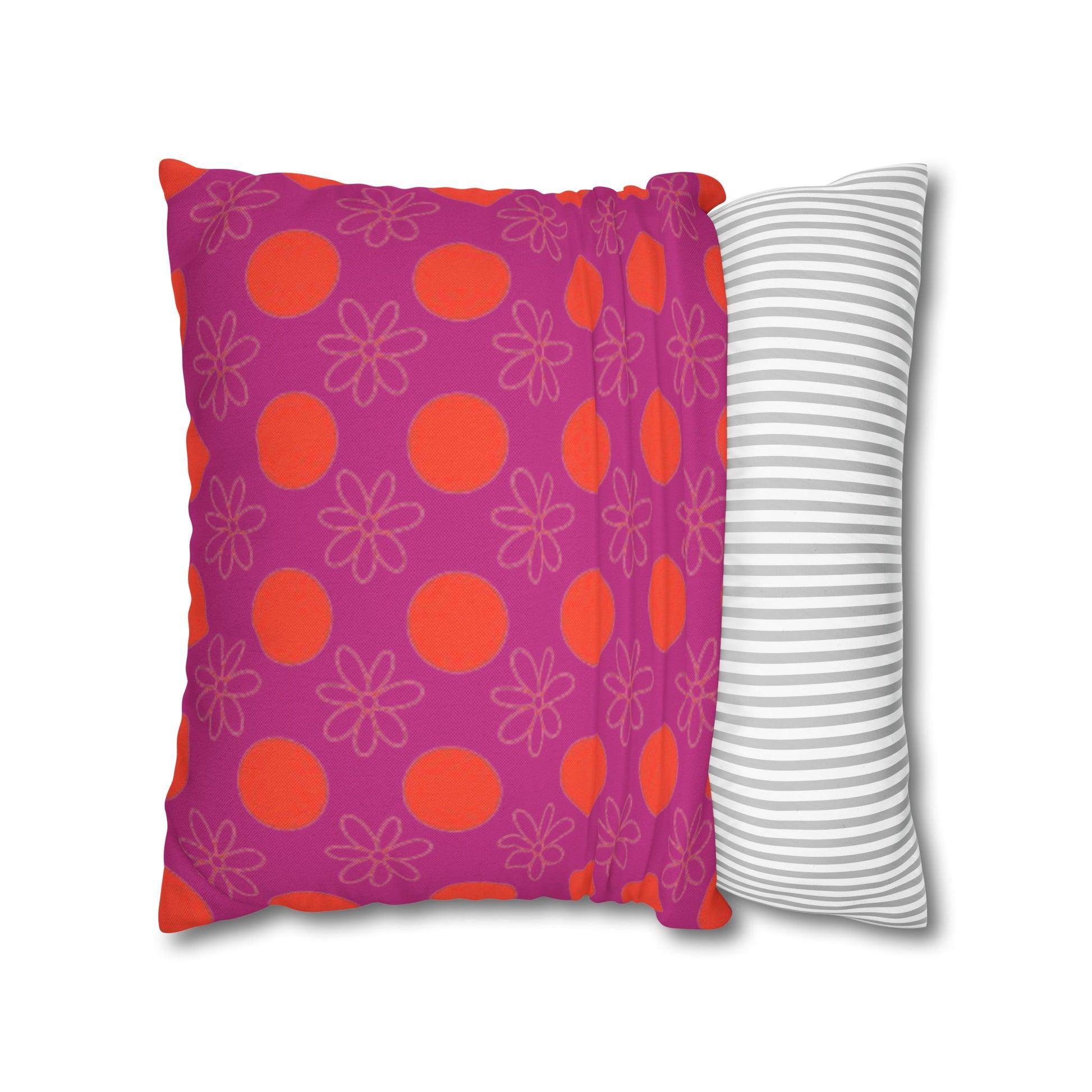 pillow with patterned covers, one pink with red circles and floral designs, the other white with gray stripes, on a white background.