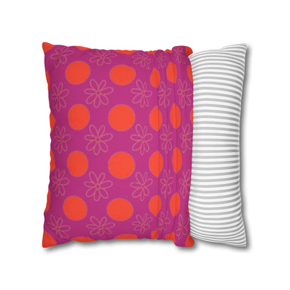 pillow with patterned covers, one pink with red circles and floral designs, the other white with gray stripes, on a white background.