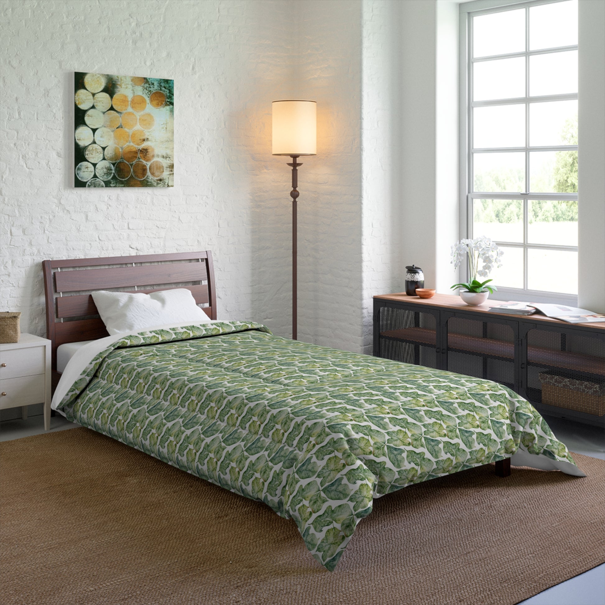 A comforter with a geometric pattern in shades of green and white, displayed against a white background.