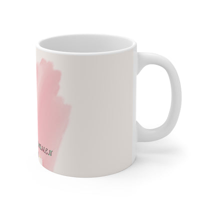 White mug with pink floral design on a white background