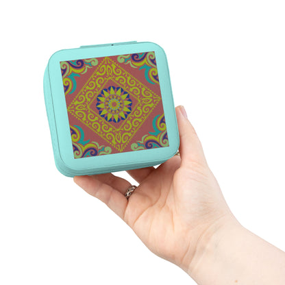 Hand holding a small square travel jewelry case with a colorful pattern on a white background