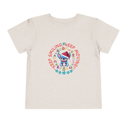 Toddler t-shirt with a cute dog illustration and motivational quote "Keep Smiling Keep Moving" printed in the center.