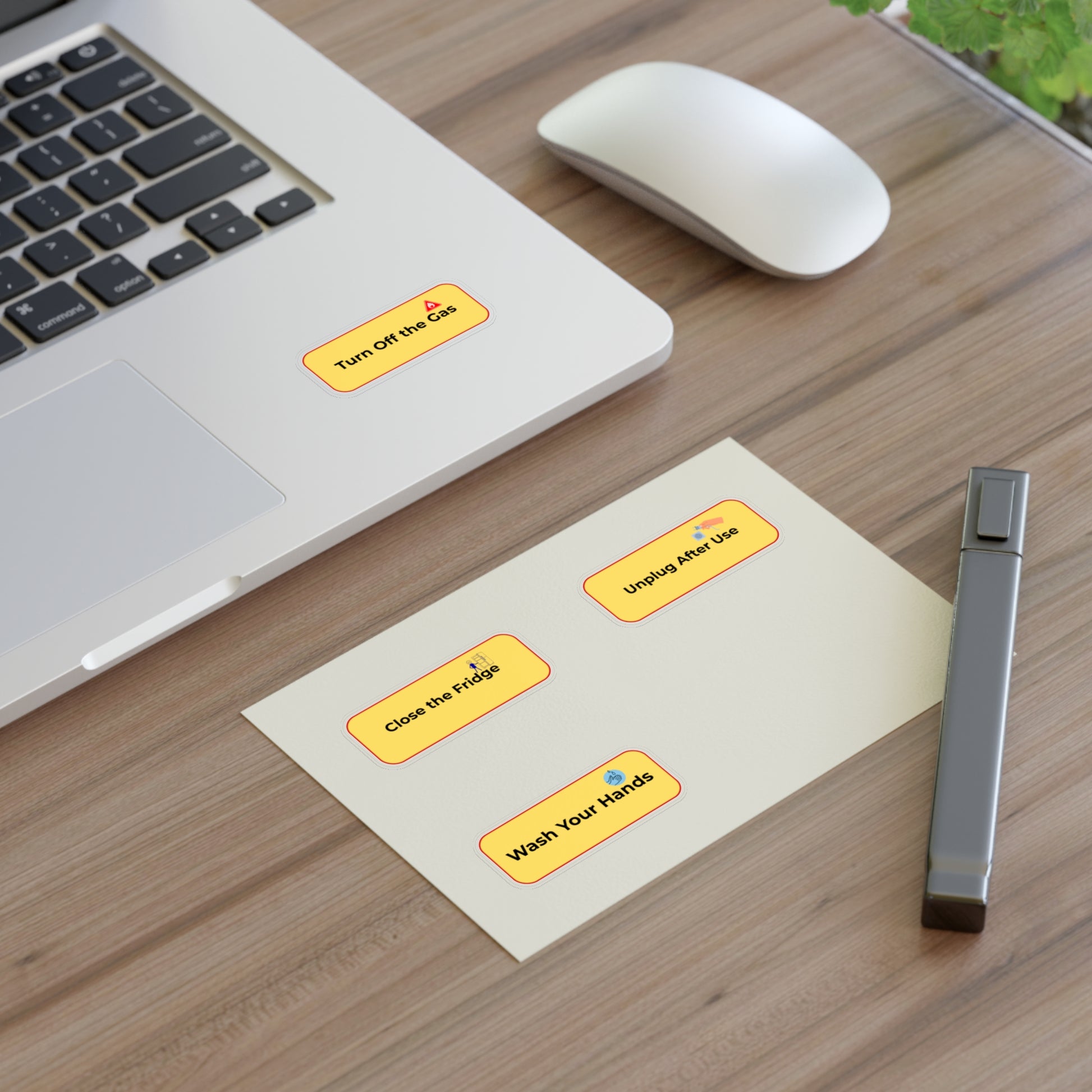 Laptop on a desk with health reminder stickers and a vape device.