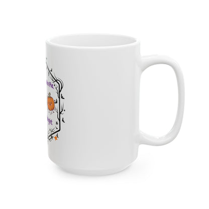 A white ceramic mug with a Halloween-themed graphic print featuring a small orange pumpkin, black bats, and purple text, shown on a clean white background.