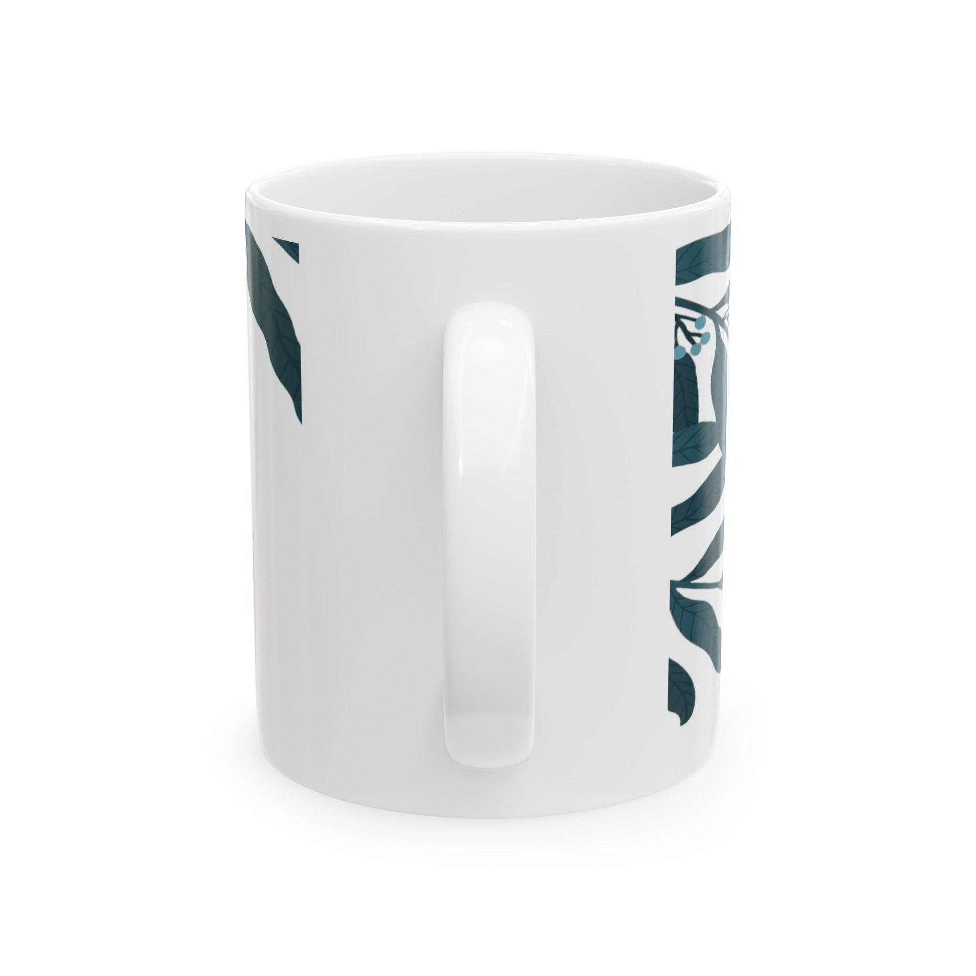 White mug with green leaf pattern on a white background