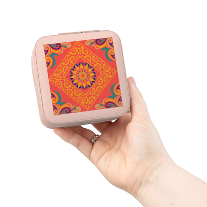Hand holding a small square travel jewelry case with a colorful pattern on a white background