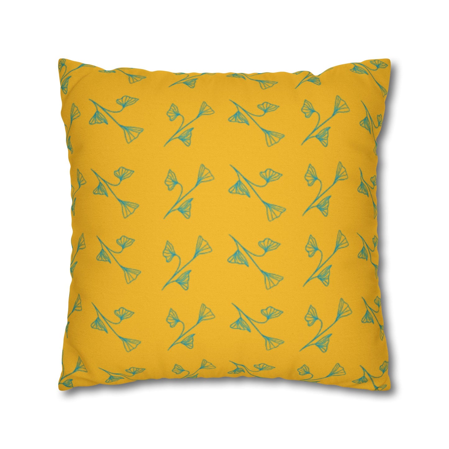 Yellow pillow with green floral pattern on a white background