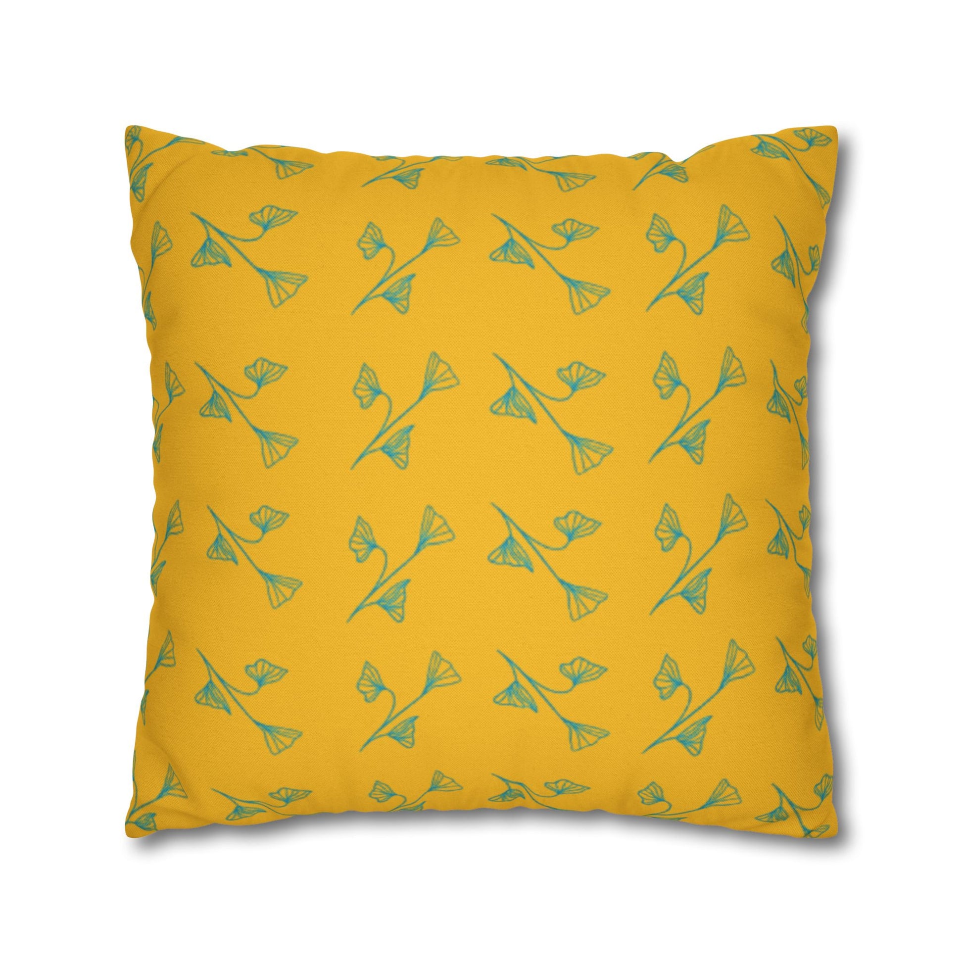 Yellow pillow with green floral pattern on a white background
