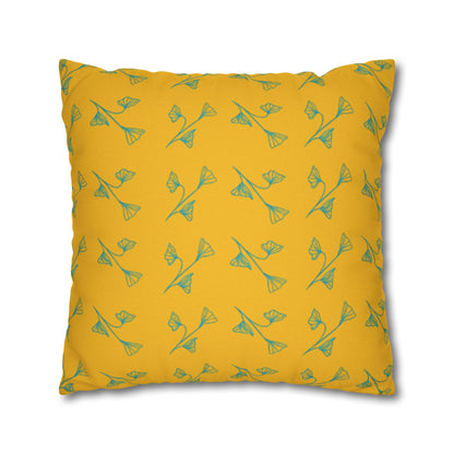 Yellow pillow with green floral pattern on a white background