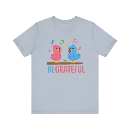 T-shirt with “Be Grateful” text and two bird illustrations – inspirational and nature-themed design for everyday wear.
