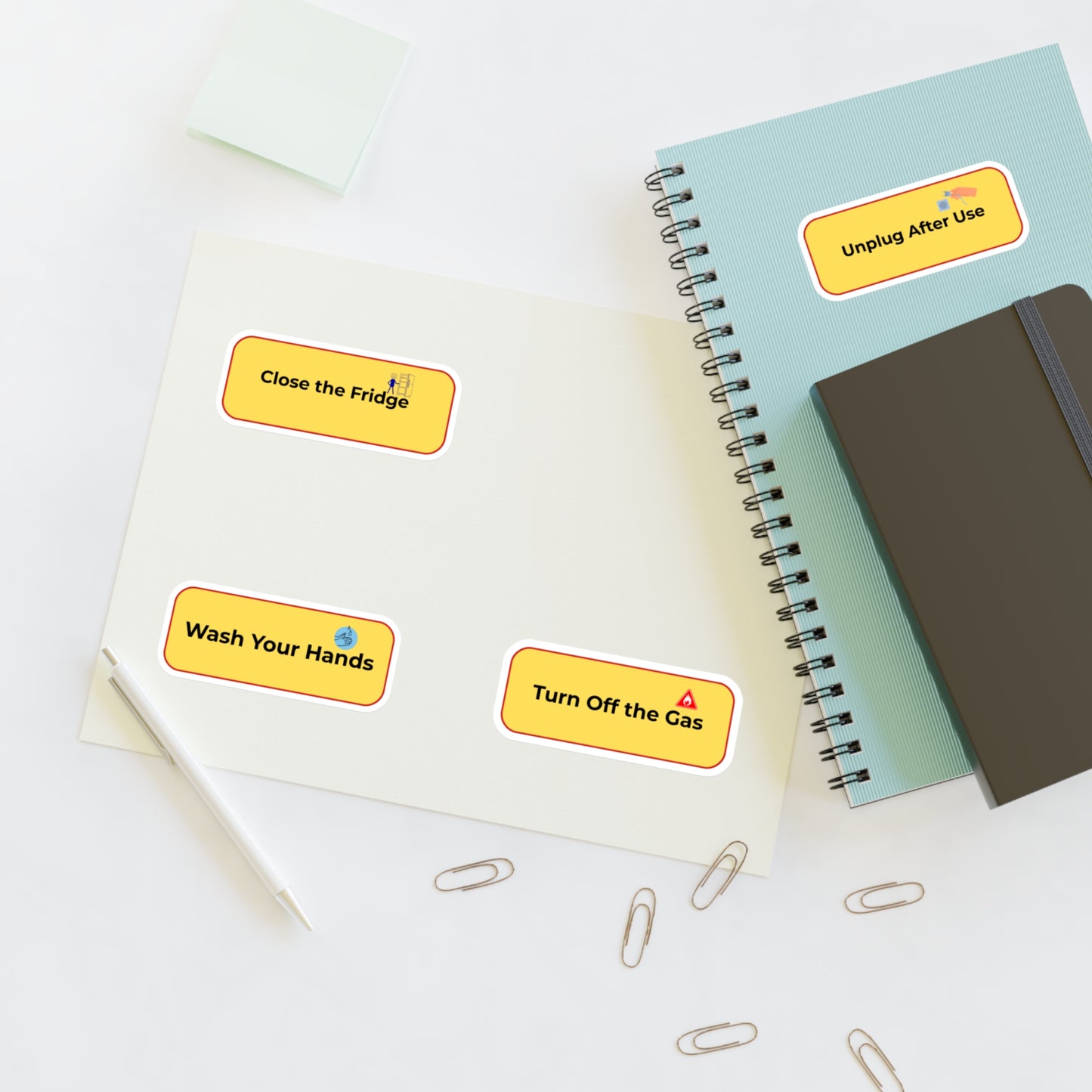 Notebooks with safety reminder stickers on a white surface
