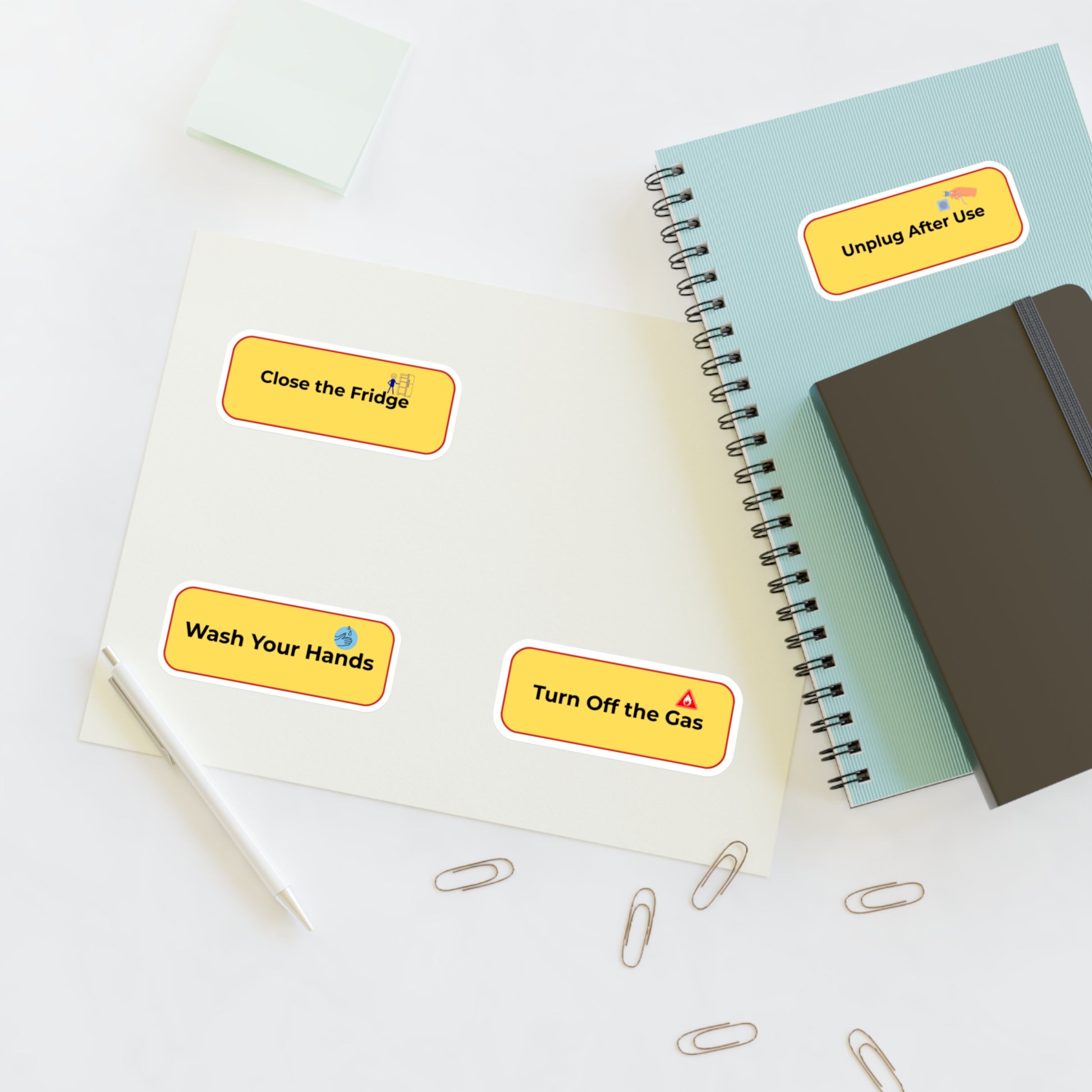Notebooks with safety reminder stickers on a white surface