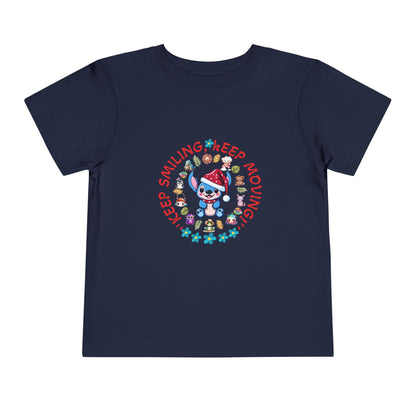 Toddler t-shirt with a cute dog illustration and motivational quote "Keep Smiling Keep Moving" printed in the center.