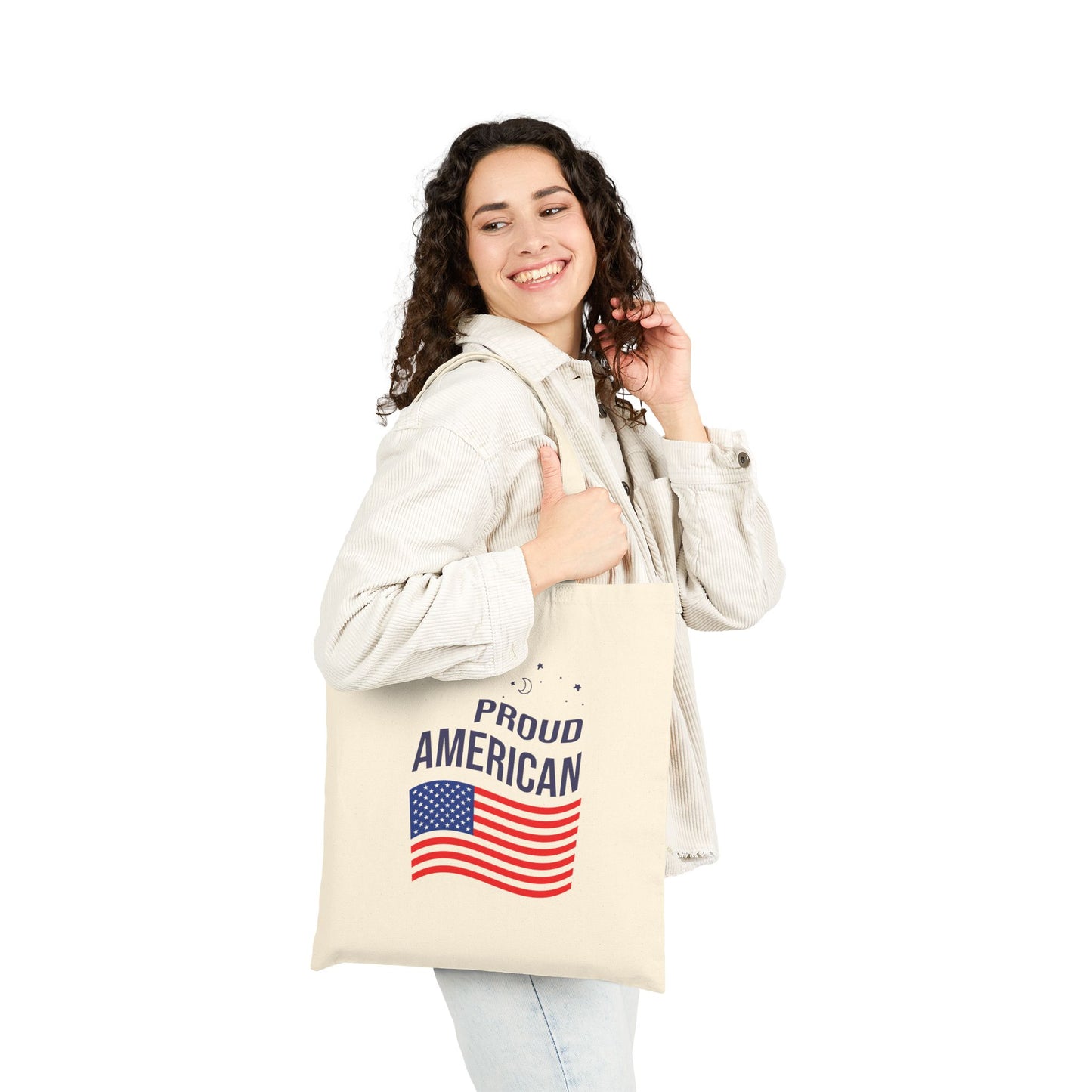 Woman holding a tote bag with 'Proud American' text and flag design on a white background
